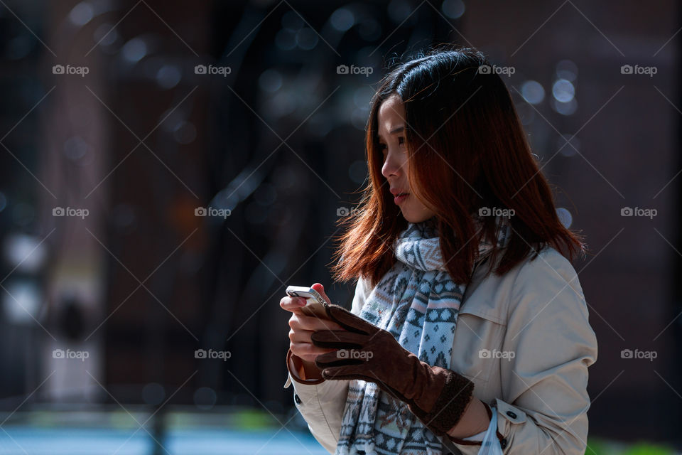 Girl playing smartphone 