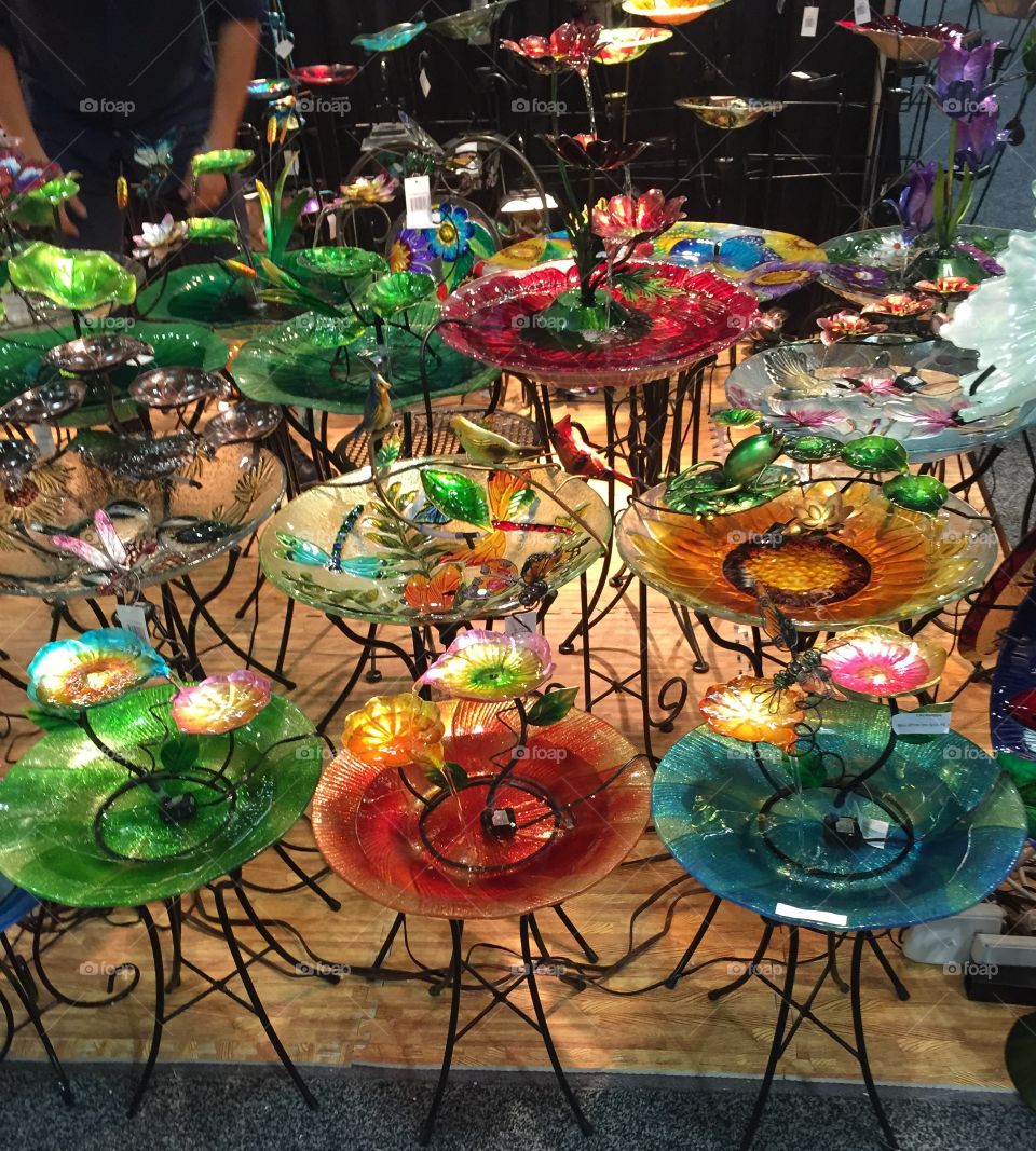 Colorful Glass Birdbaths. Trade show Birdbaths in colorful glass with wire bases. 
