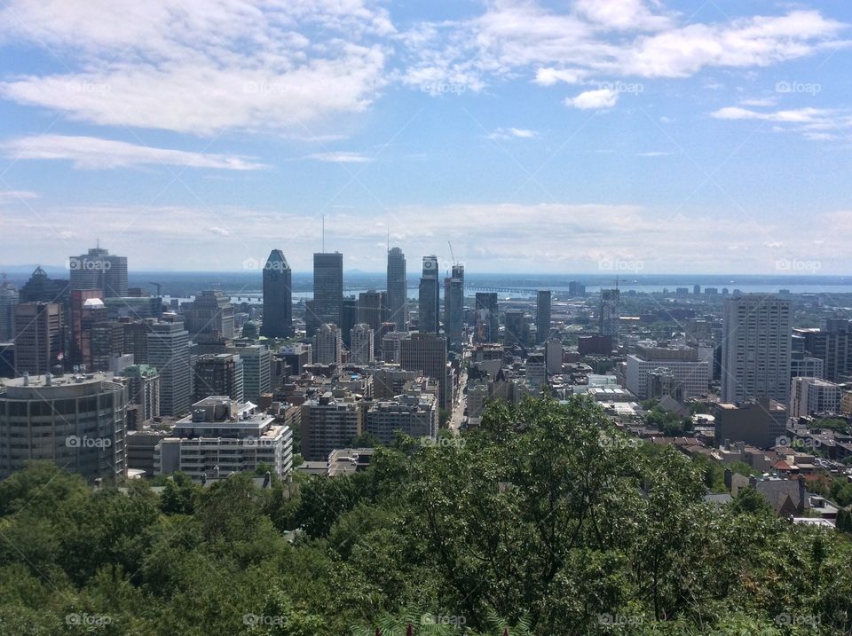 My view of the city of Montreal from the scenic view point of Mount Royal in the summertime.