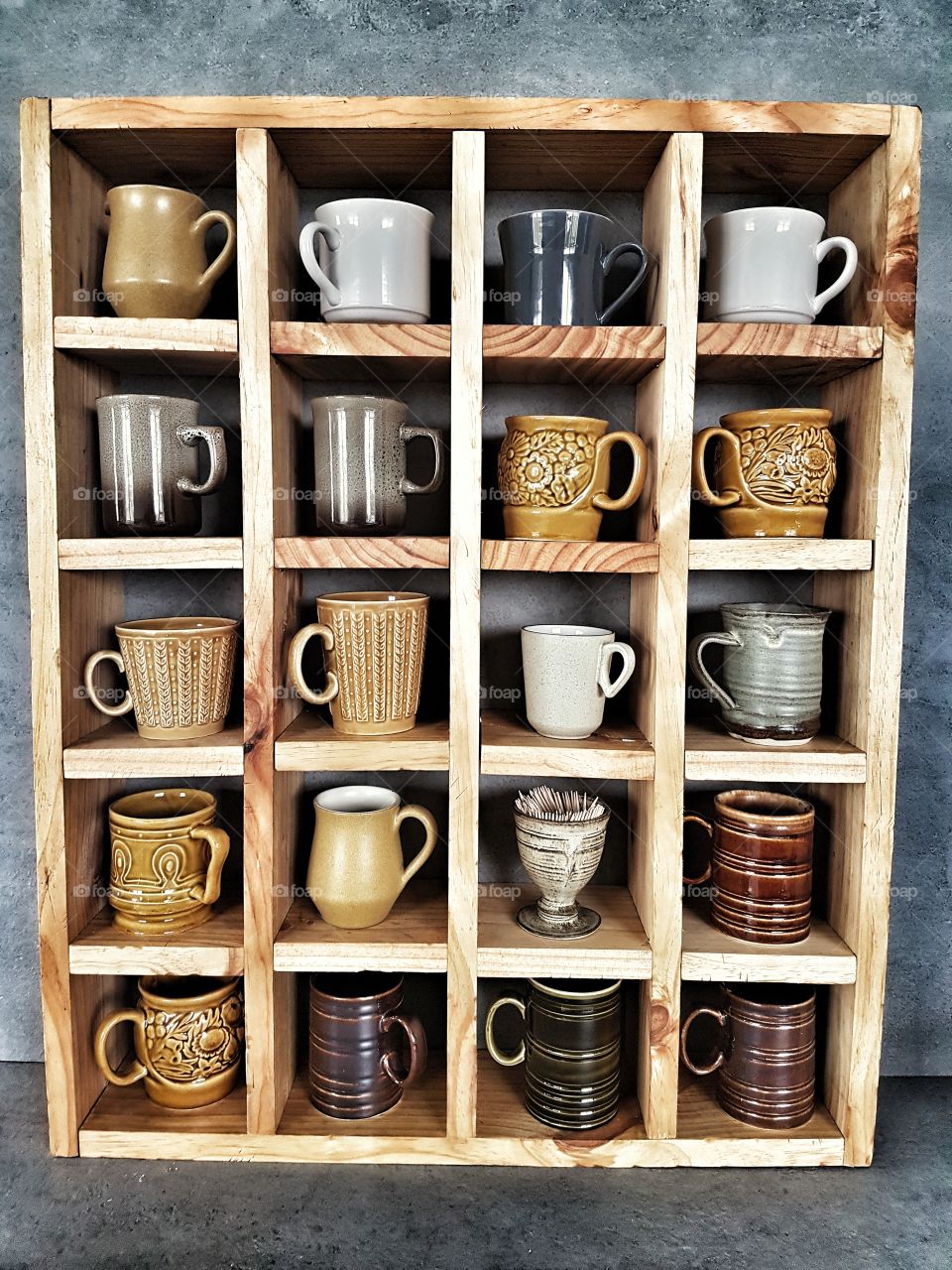 collection of vintage mugs and pottery on old rustic wooden shelf