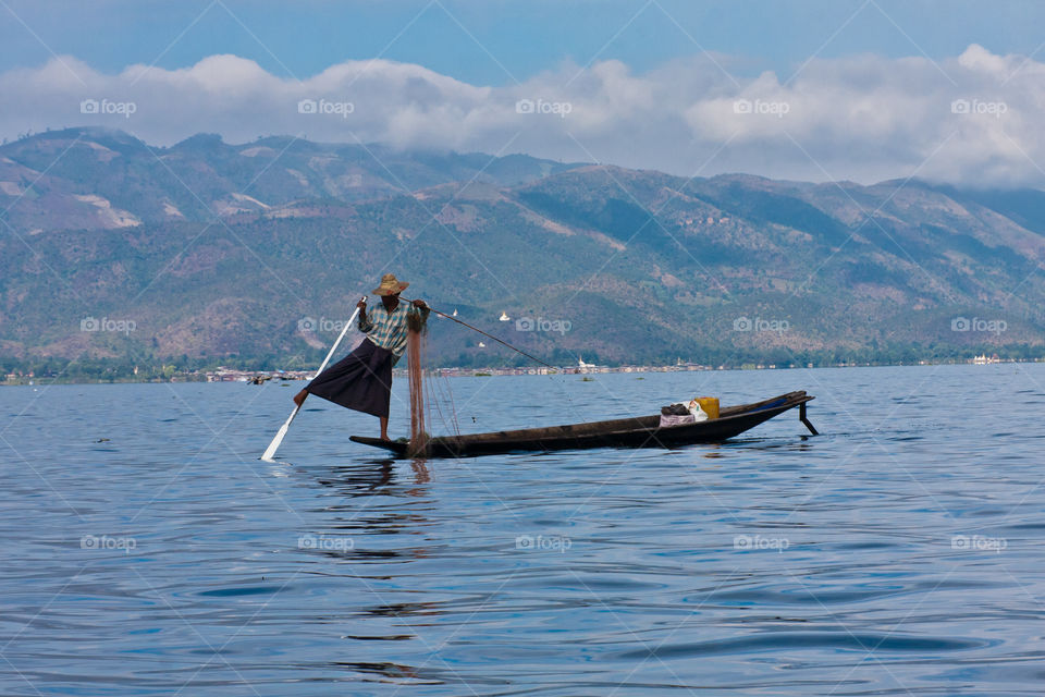 An iconic leg-rowing Intha fisherman on the Inle Lake, Myanmar