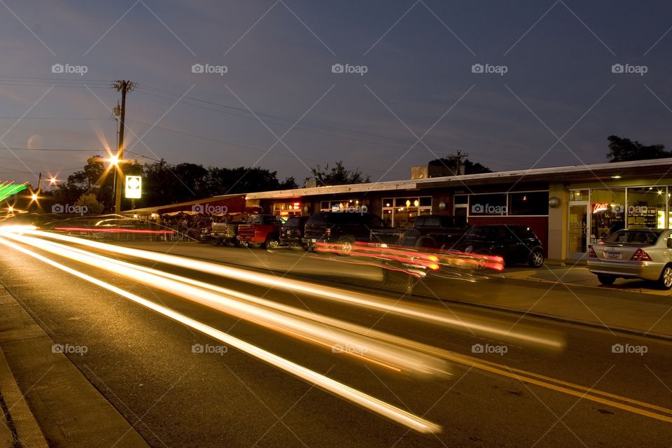 Headlights streaking down street at night