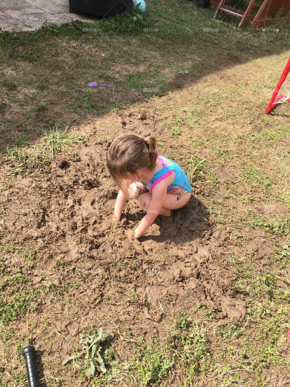 Girl in mud pit