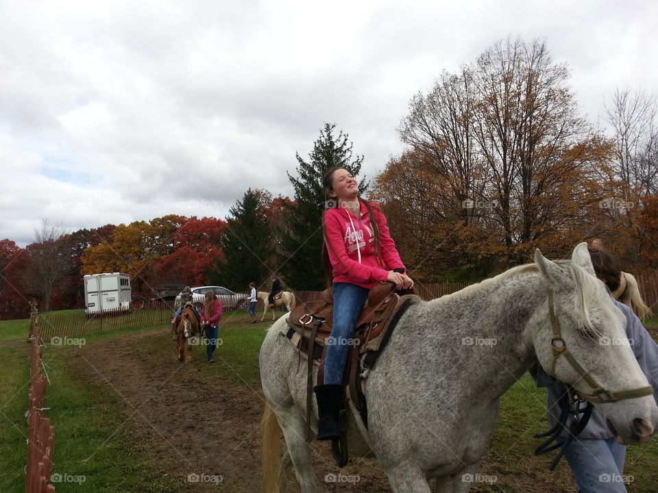 This photo features our daughter enjoying a horse ride at Hozak's Farm in Pennsylvania before Halloween - and her priceless laughter is due to the fact that the horse just "relieved" himself with a bowel movement (AKA took a poo) as she was passing by...
