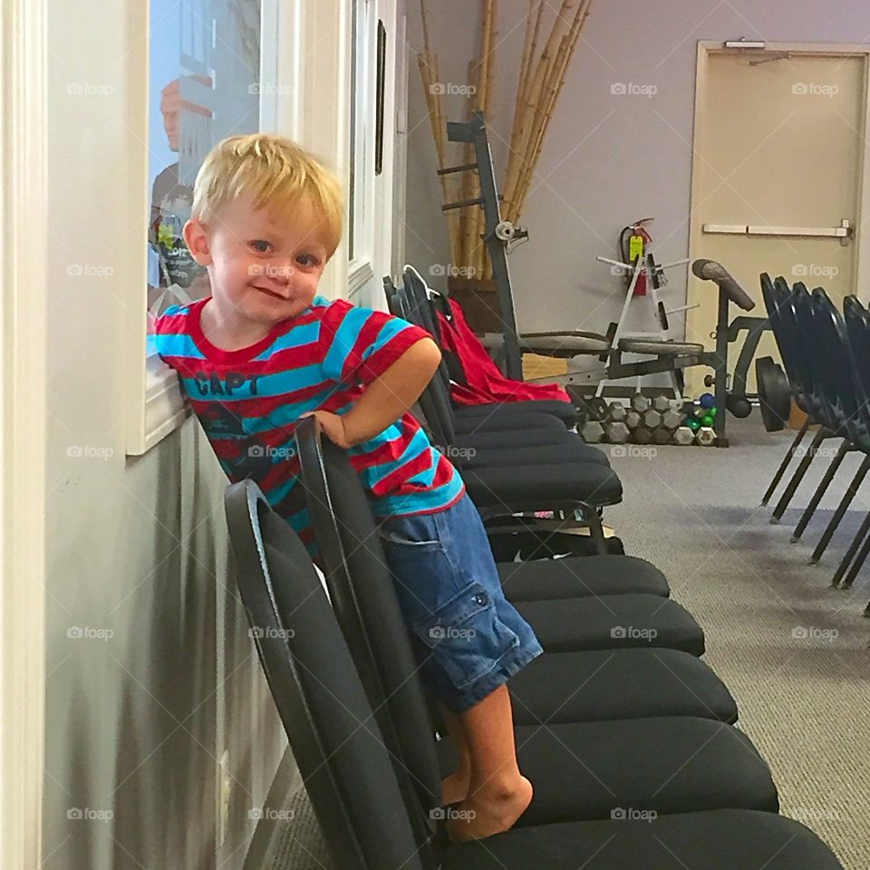 Portrait of a boy standing on chair