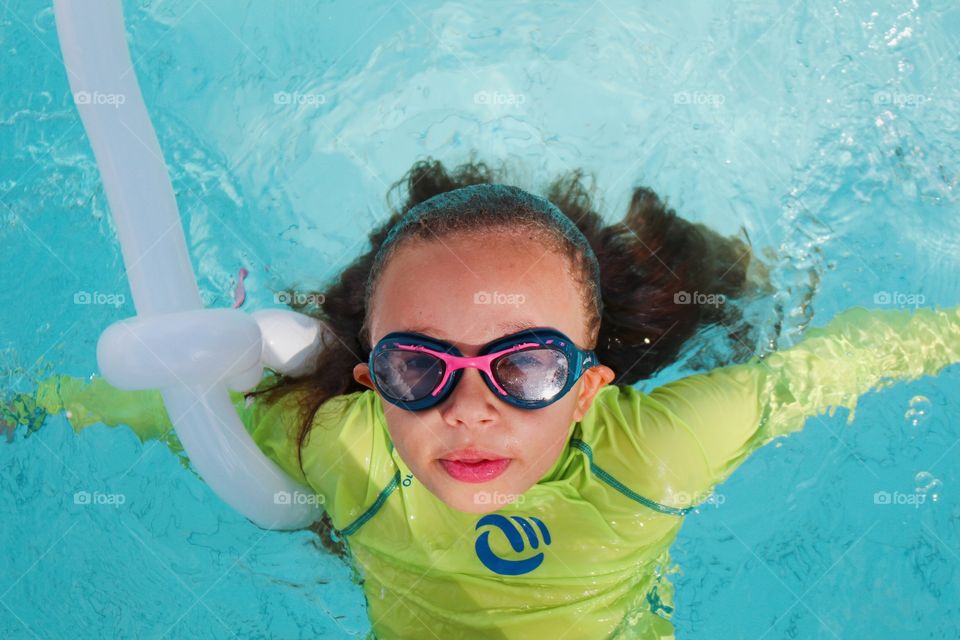 Little girl swimming in the pool