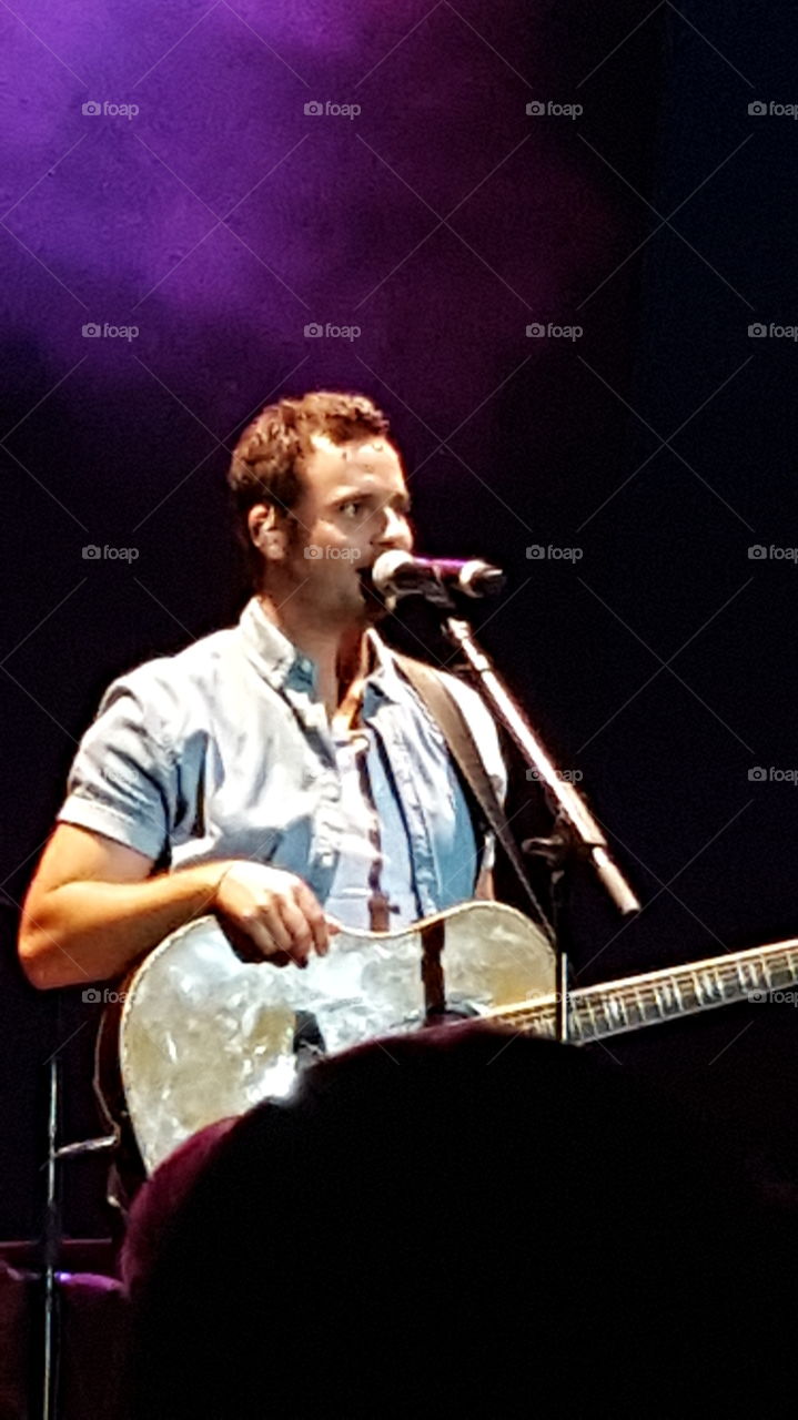 singing and dancing while playing the guitar