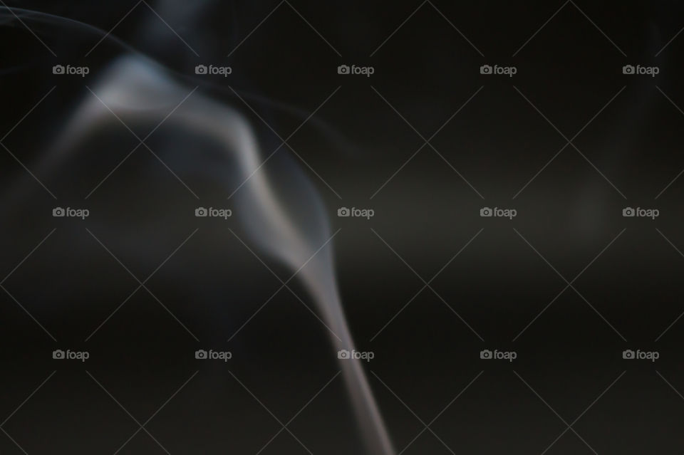 Smoke scented candles on a black background