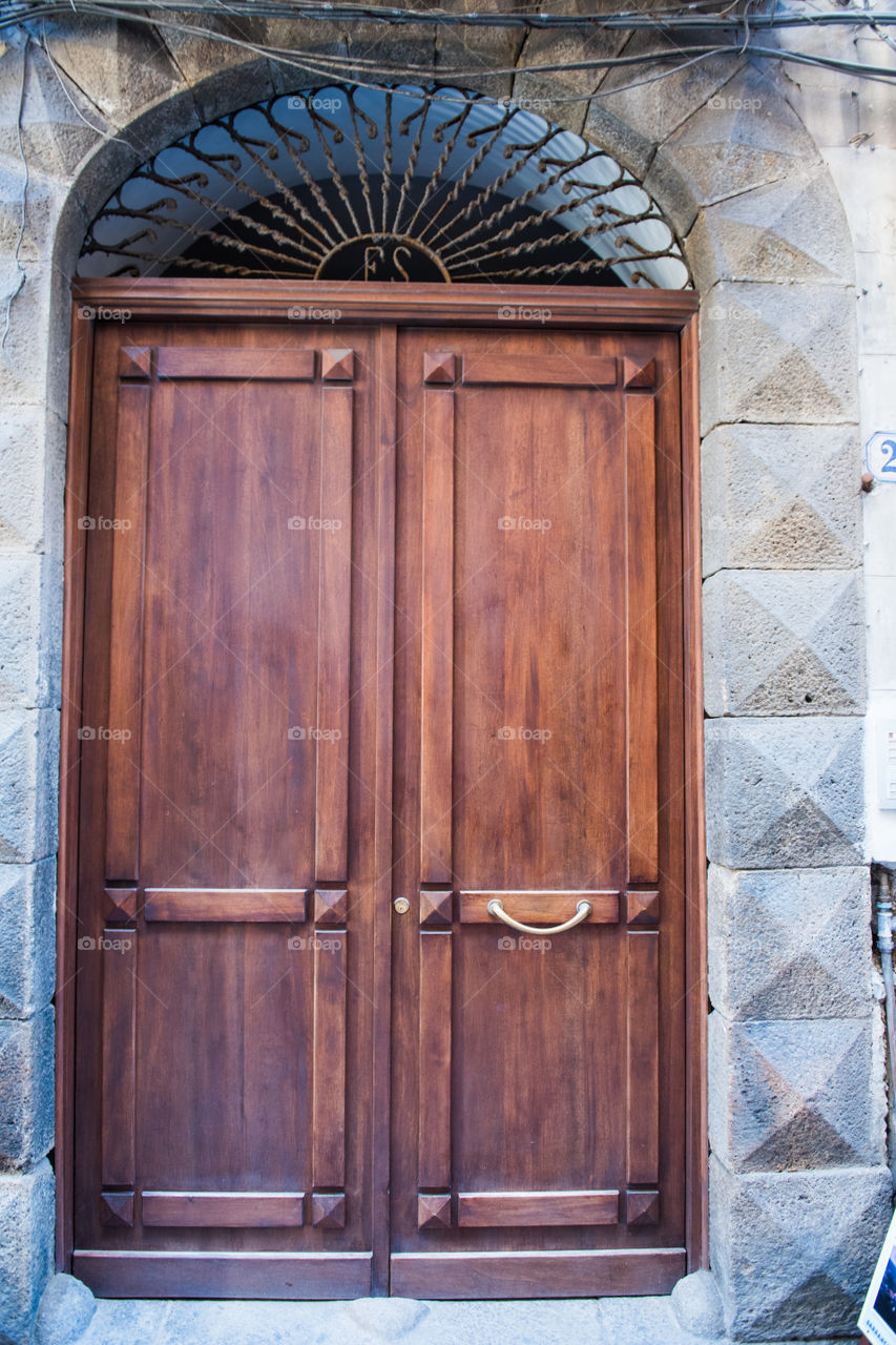 Old door in the city of Cefalu on Sicily.