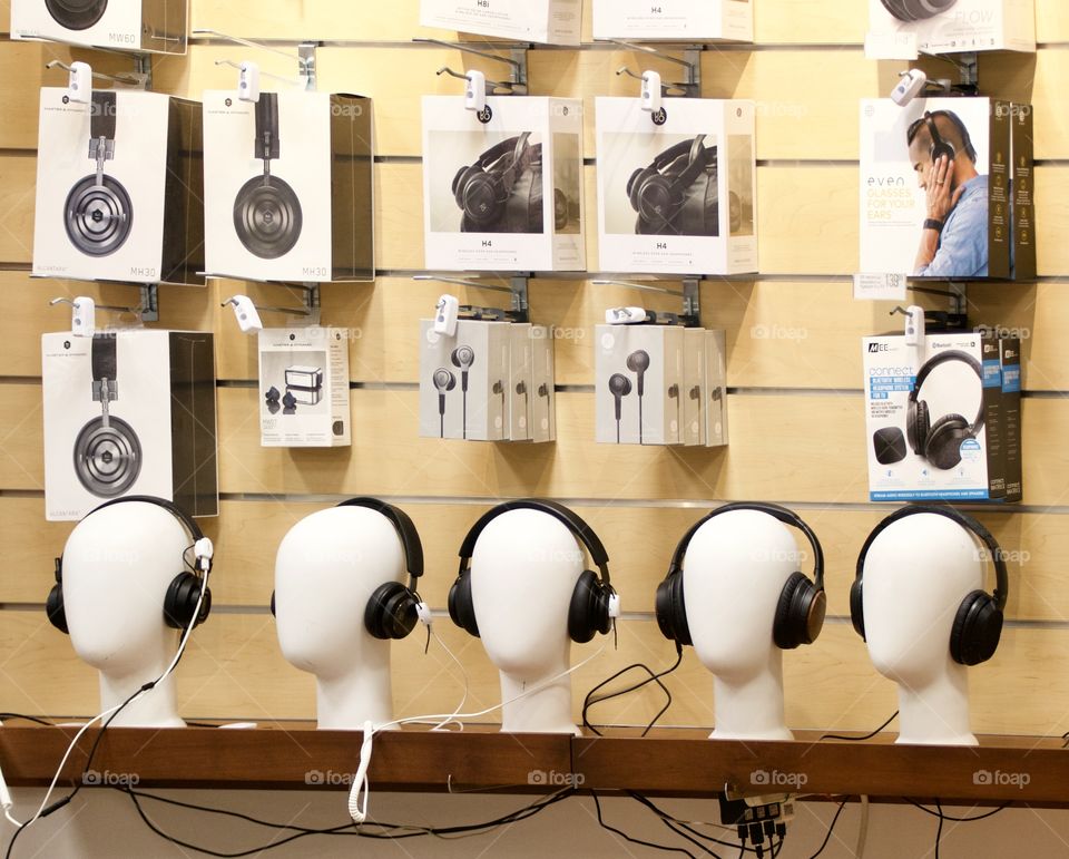 Several mannequin heads displayed with headphones on.