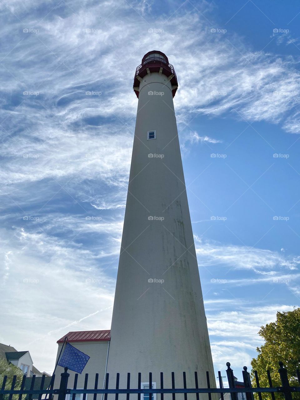 Looking up at the Cape May Lighthouse.  199 steps to the top. Blue sky, white wispy clouds background.