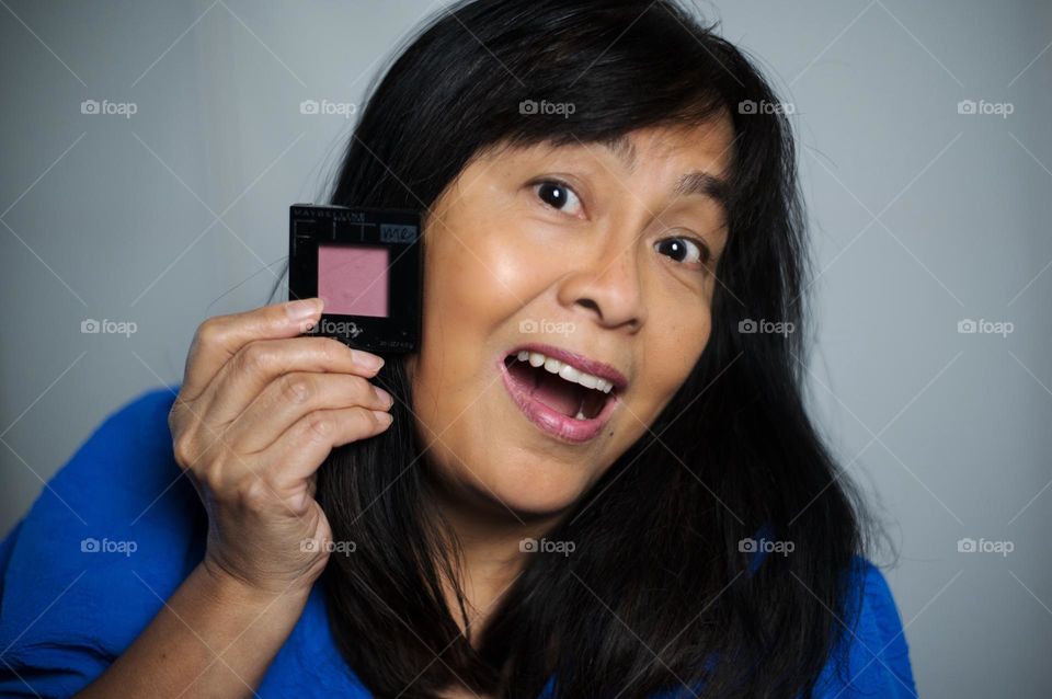 Woman holding a blush on makeup 