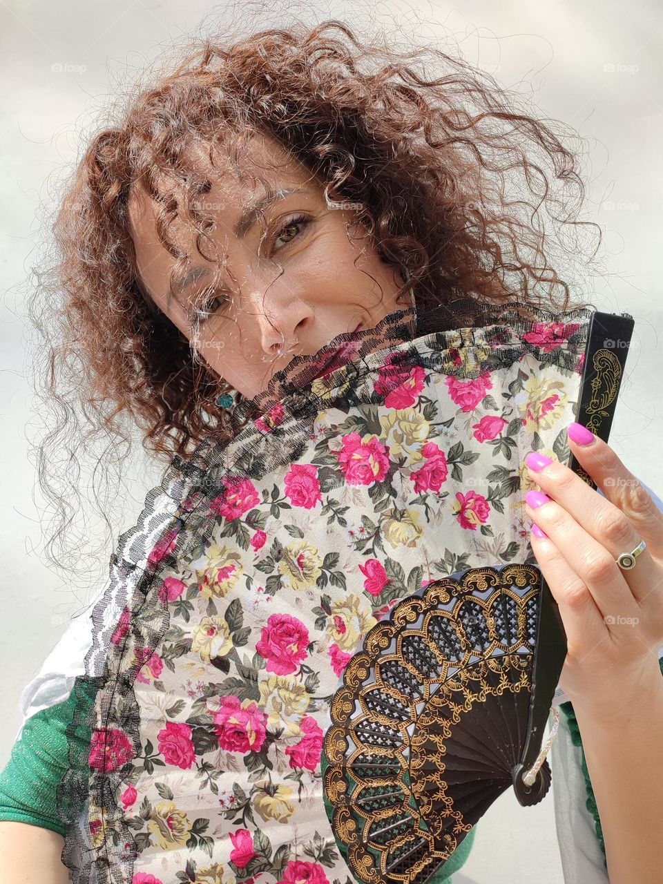 Portrait of a woman brunette with a fan