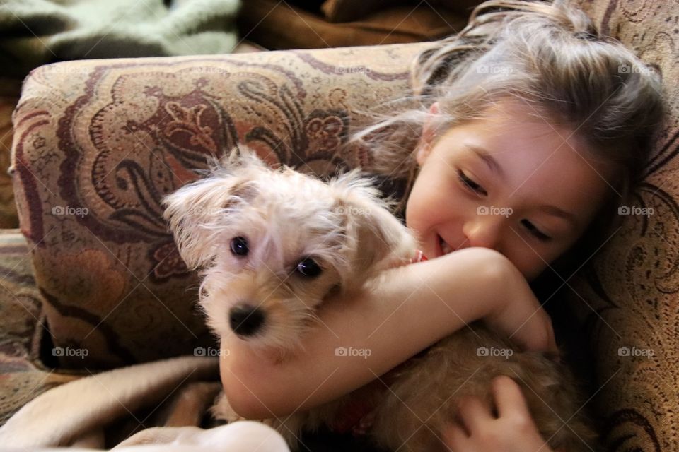 Girl holding Yorkiepoo puppy