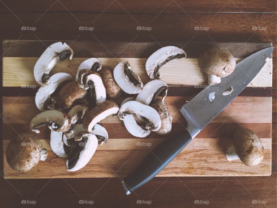 Slice of mushrooms on cutting board