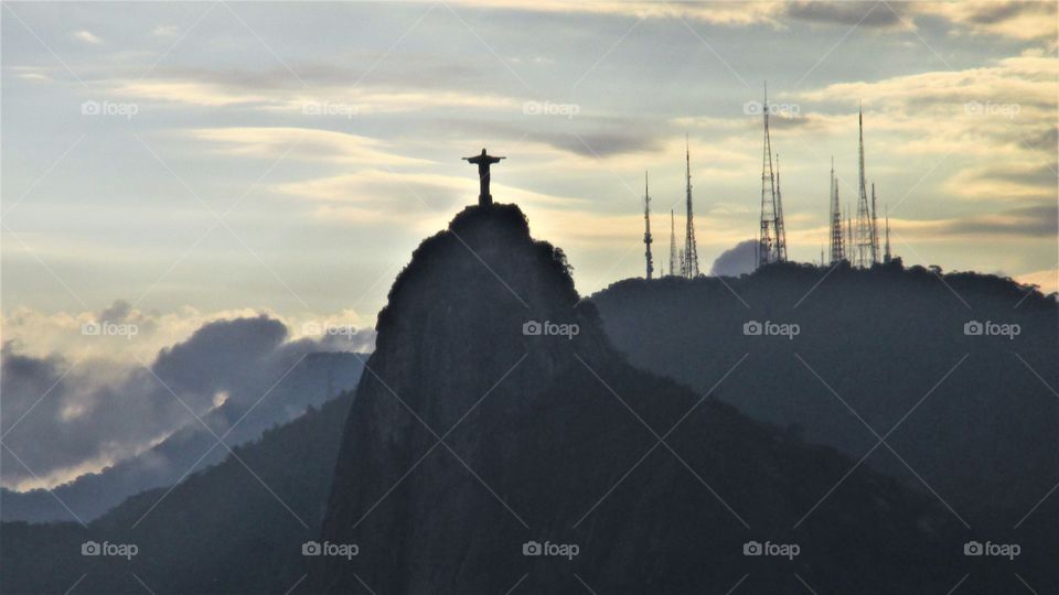 Christ the redeemer at sunset: view from the top of their sugar loaf - Rio de Janeiro, Brazil