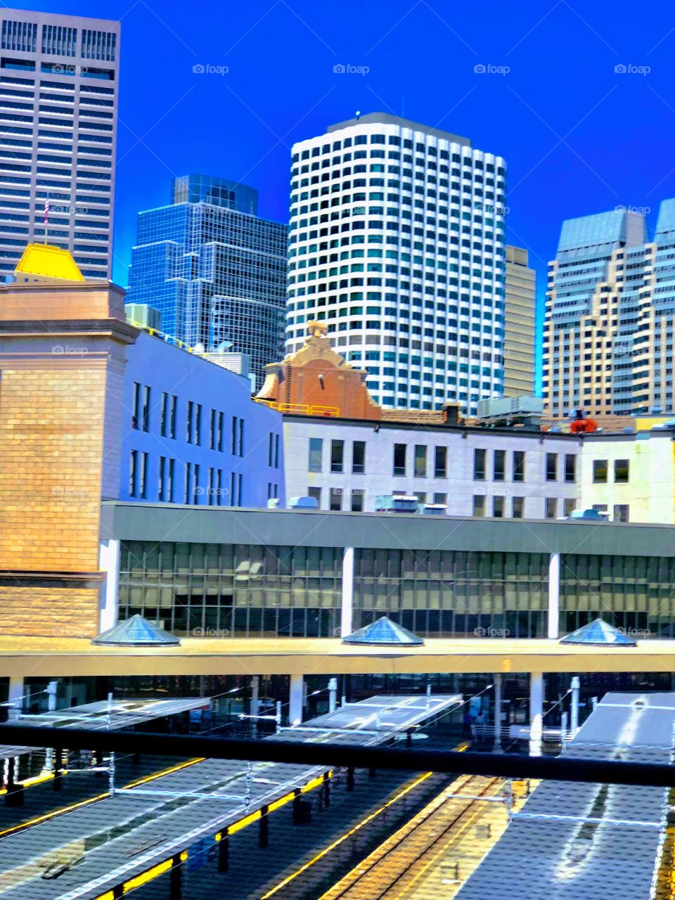 View of buildings and Boston skyline during the day from window on a bus leaving from  or arriving to South Station.