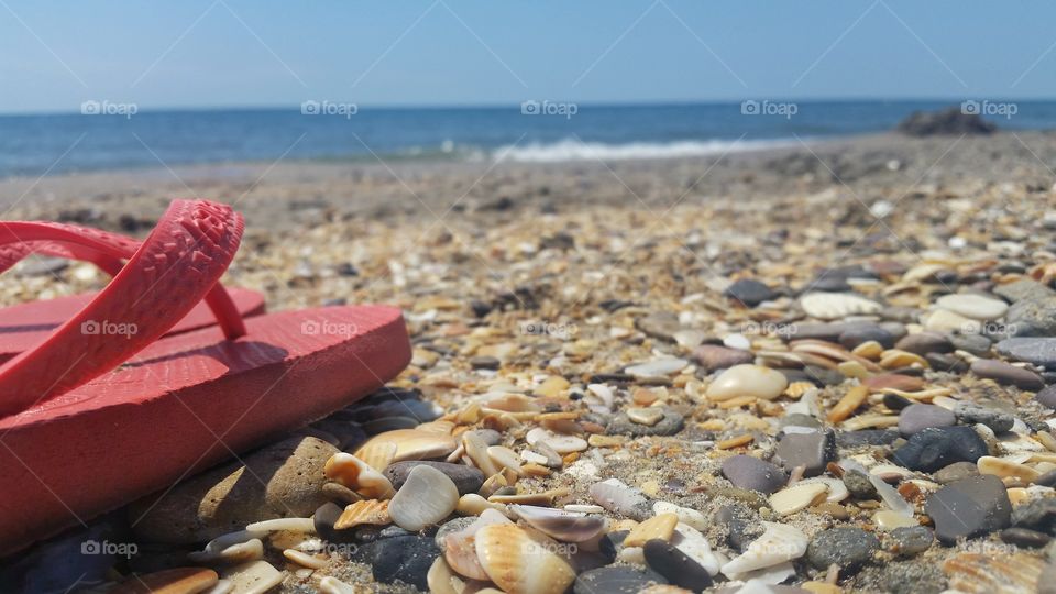 One slipper on the rocky beach of Sete in France