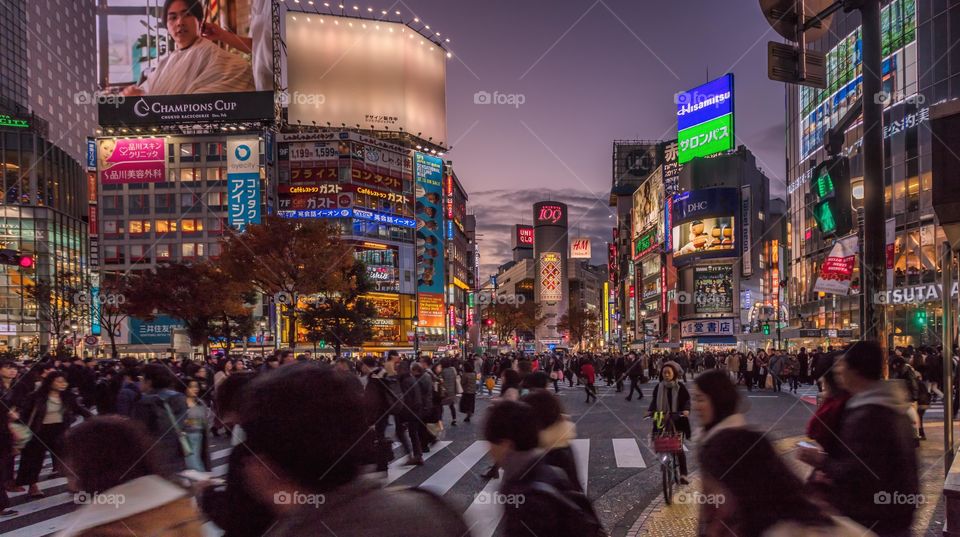 Busy shibuya crossing at sunset