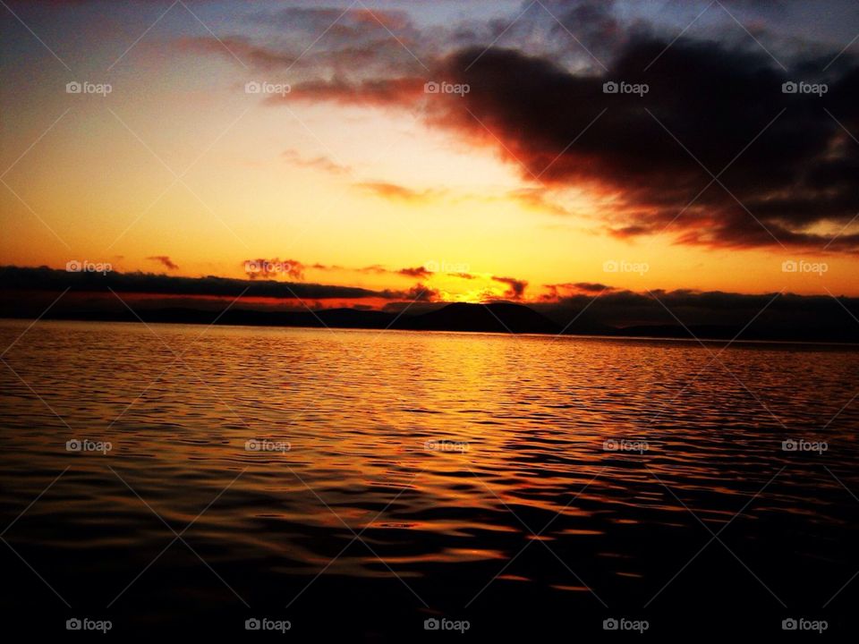 Dramatic sky reflected on sea