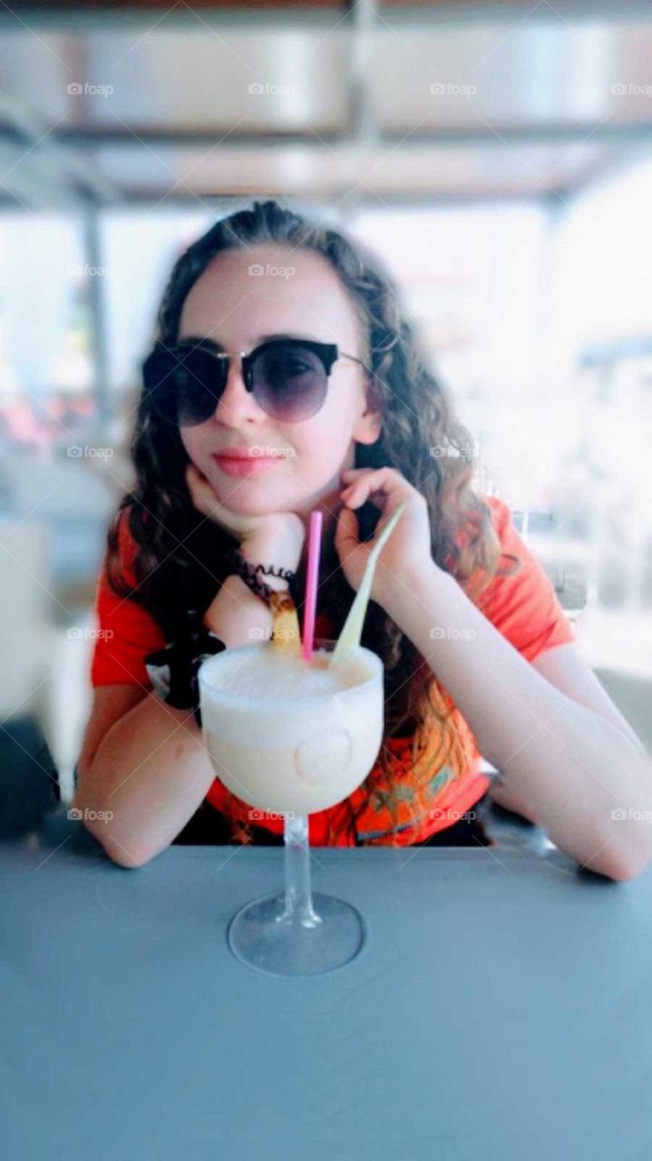 teenage girl enjoying an exotic drink in vacation