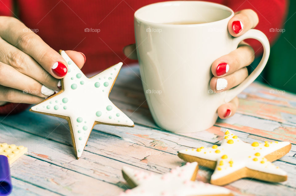 Women holding star shape cookie