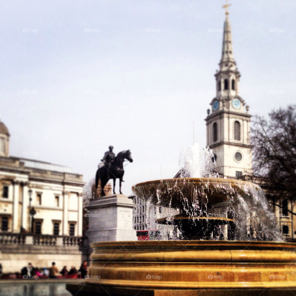 Fountain and statue in Trafalgar Square in London in April