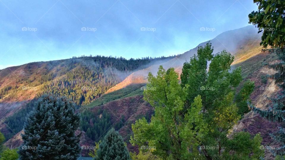 Early morning fog, sunrise on the mountain and late summer colors combine to create this spectacular view.