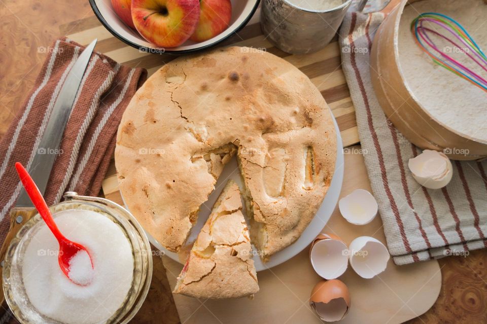 Making homemade puffed apple pie with eggs, sugar and flour.