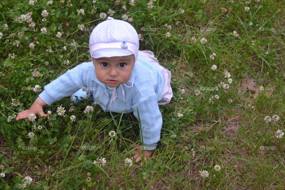 Cute boy playing in meadow