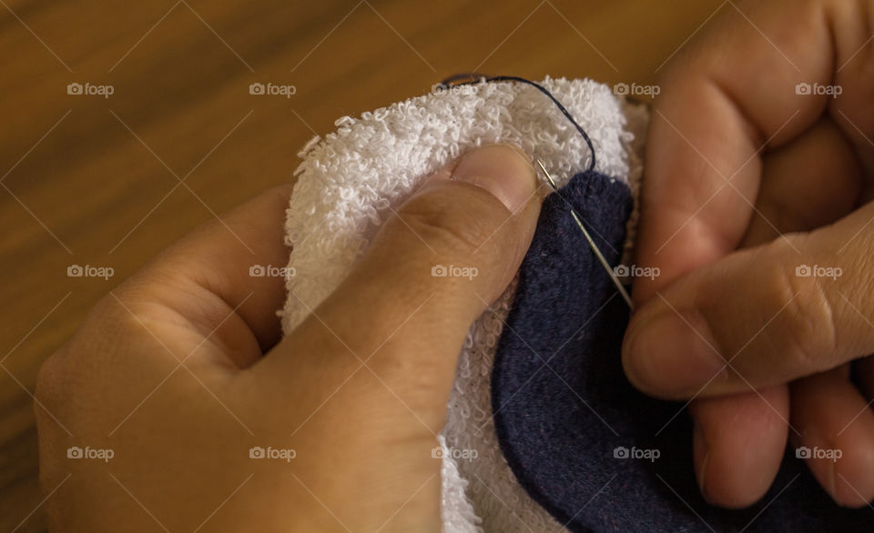 Close-up of a woman sewing with needle