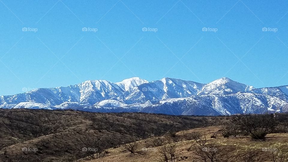 Snowcapped mountain range against clear sky