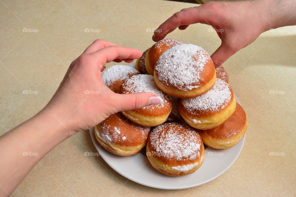 Two people holding sweet food in plate