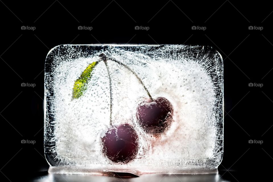 Frozen cherry in ice brick