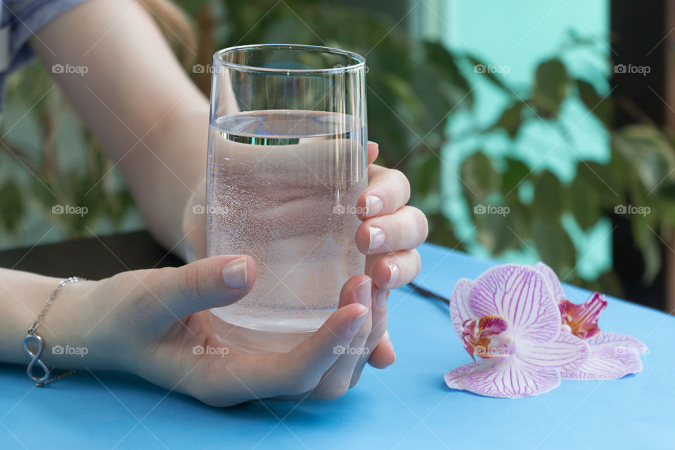 a glass of water in hands