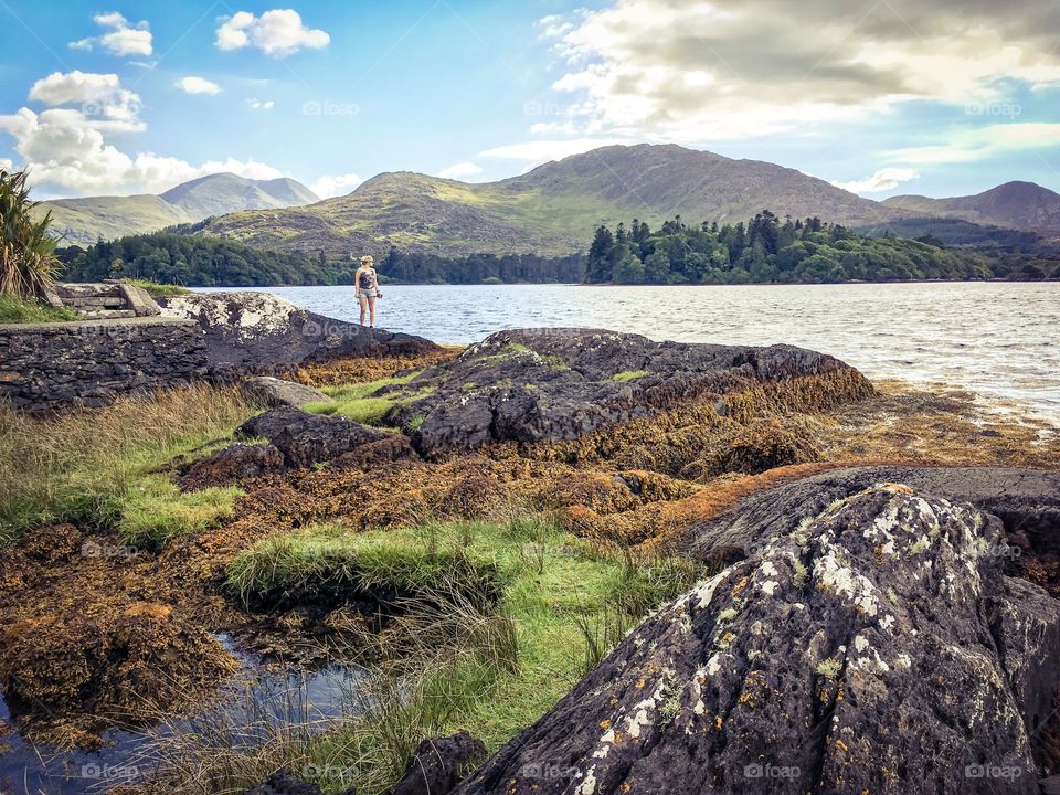 Women taking in the view of the rugged coastline. Ring of Beara, Kerry, Ireland. 
