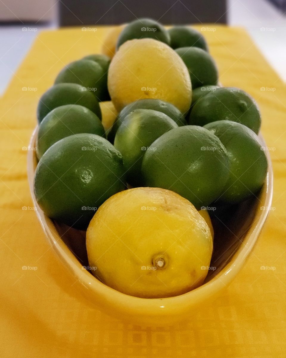 lemons and limes in a pot