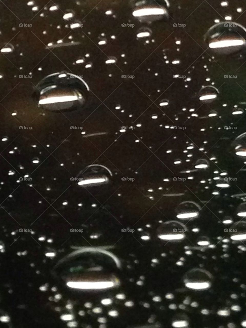 Rain drops on the windshield at night