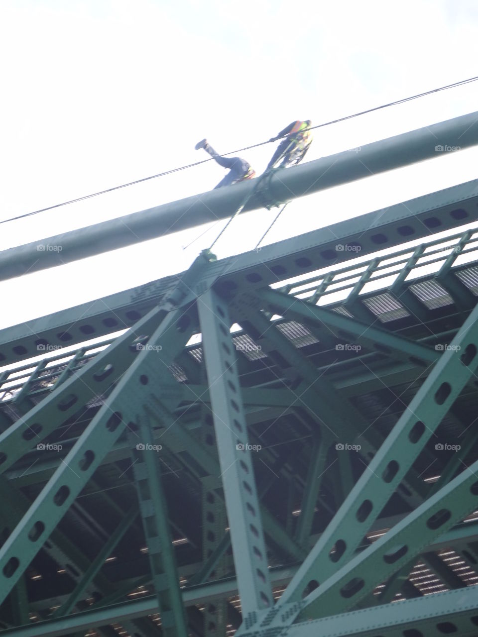 Working High. Men working on the very top of the Mackinac Bridge
