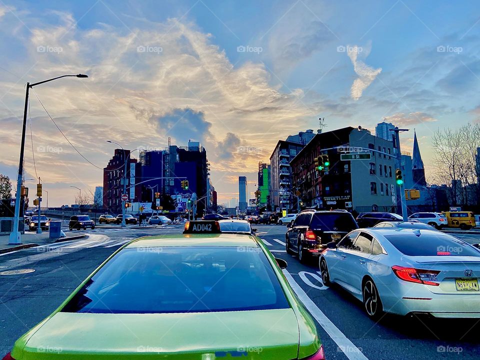 A green sportscar on it’s way from Long Island City, Queens to Bushwick, Brooklyn, NY on one of the last days of 2021 on a late afternoon photographed by Timothy riding behind him on the scooter. Hypnotic Productions