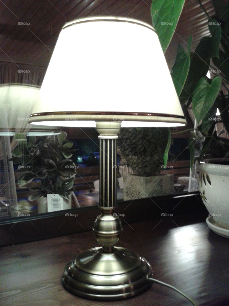 the table lamp at the window.