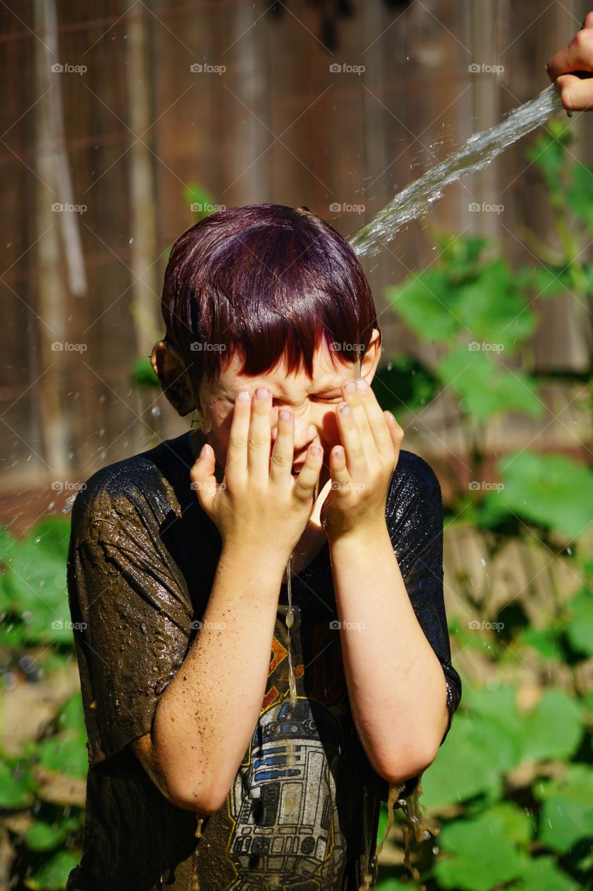 Young Boy Showered With Water