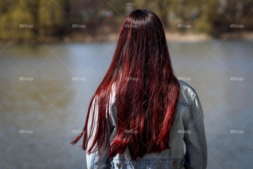 Redhead young woman by the lake