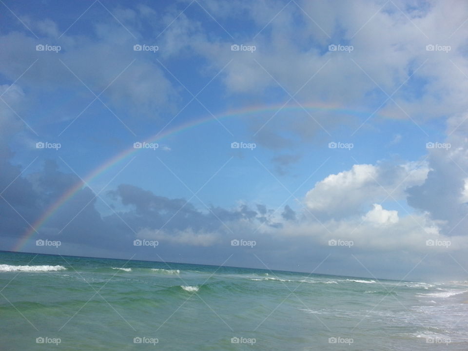 Sunday Morning on the Beach with a Rainbow