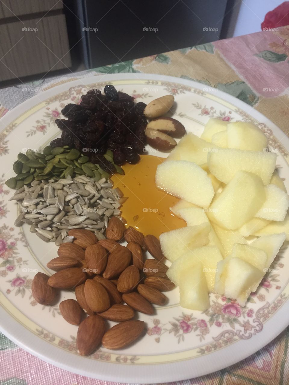 Breakfast - almonds, sunflower seeds, sliced apple, pumpkin seeds, raisins, cranberries, Brazil nuts, honey