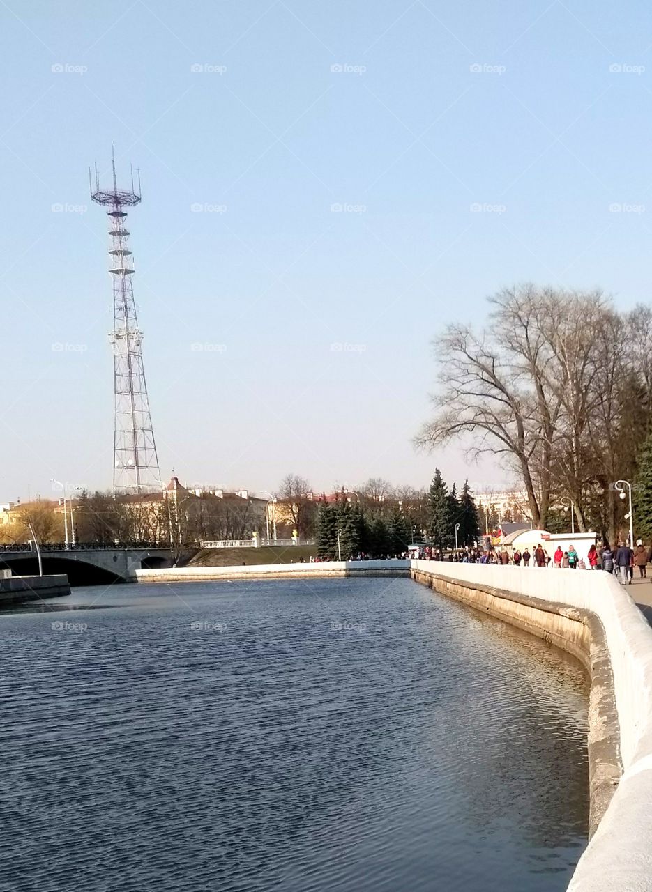 cityscape river shore and people walk