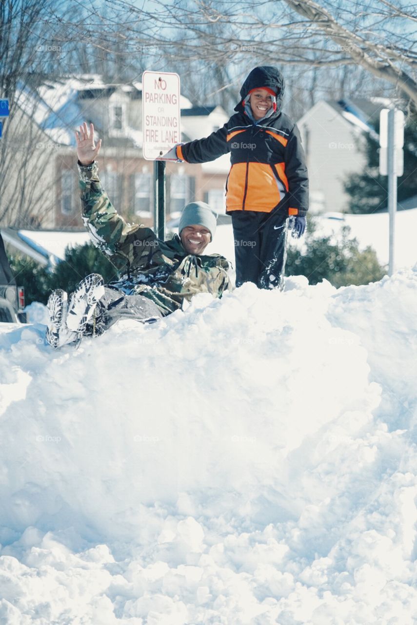 Happy father and son enjoying snow