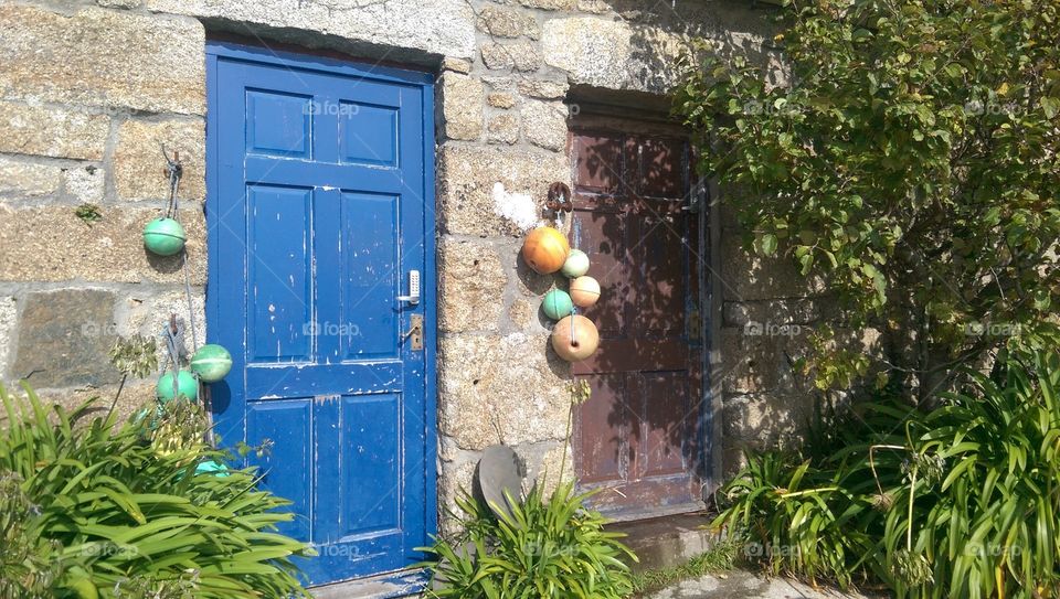 brightly coloured cottage doors in sunlight