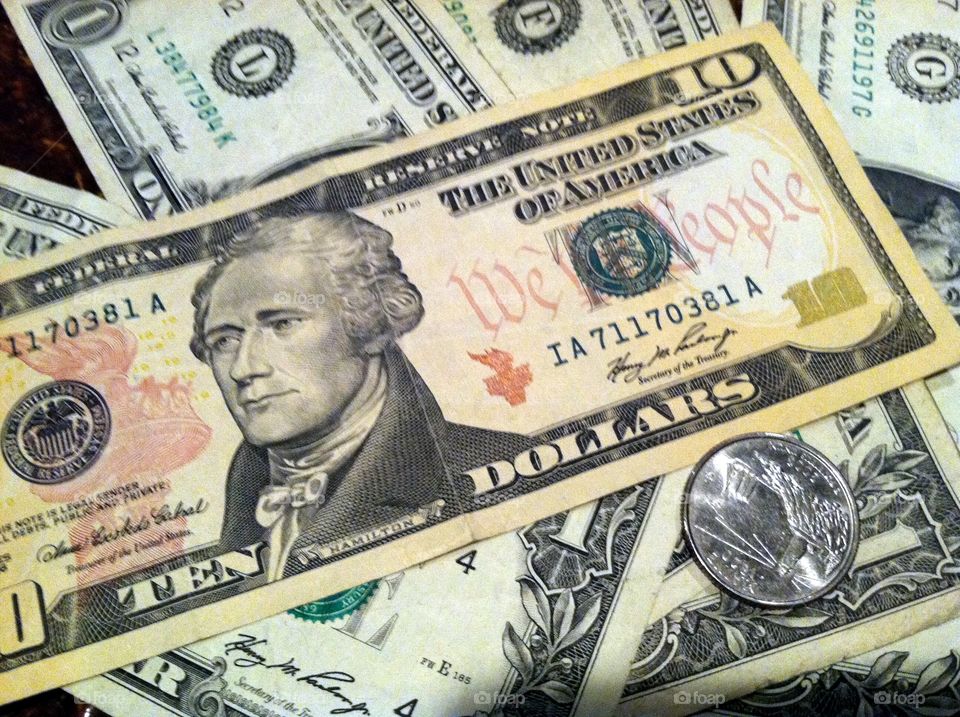U.S. Dollars sitting on a bar.