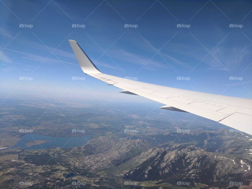 Flying High Over the Mountains and Lakes of Portugal (Airplane Wing View)